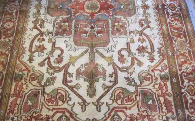 Appraisal: HAND KNOTTED ORIENTAL CARPET Persian Serapi design centering a geometric