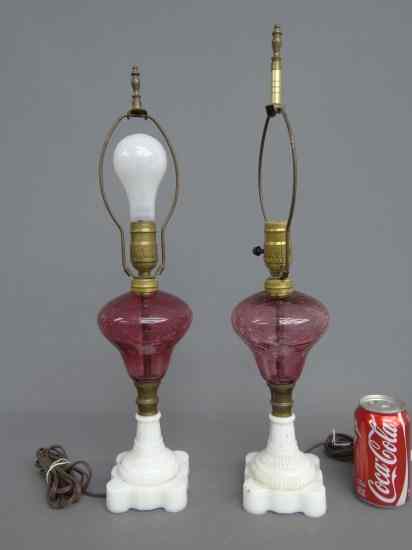 Appraisal: Pair th c cranberry milk glass oil lamps converted ''