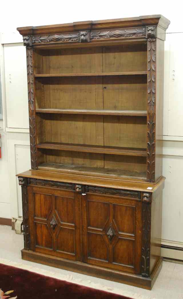 Appraisal: RELIEF-CARVED OAK BOOKCASE ON CABINET English mid- th century the