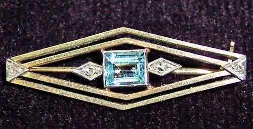 Appraisal: A lozenge shaped brooch centred by an aquamarine and diamonds