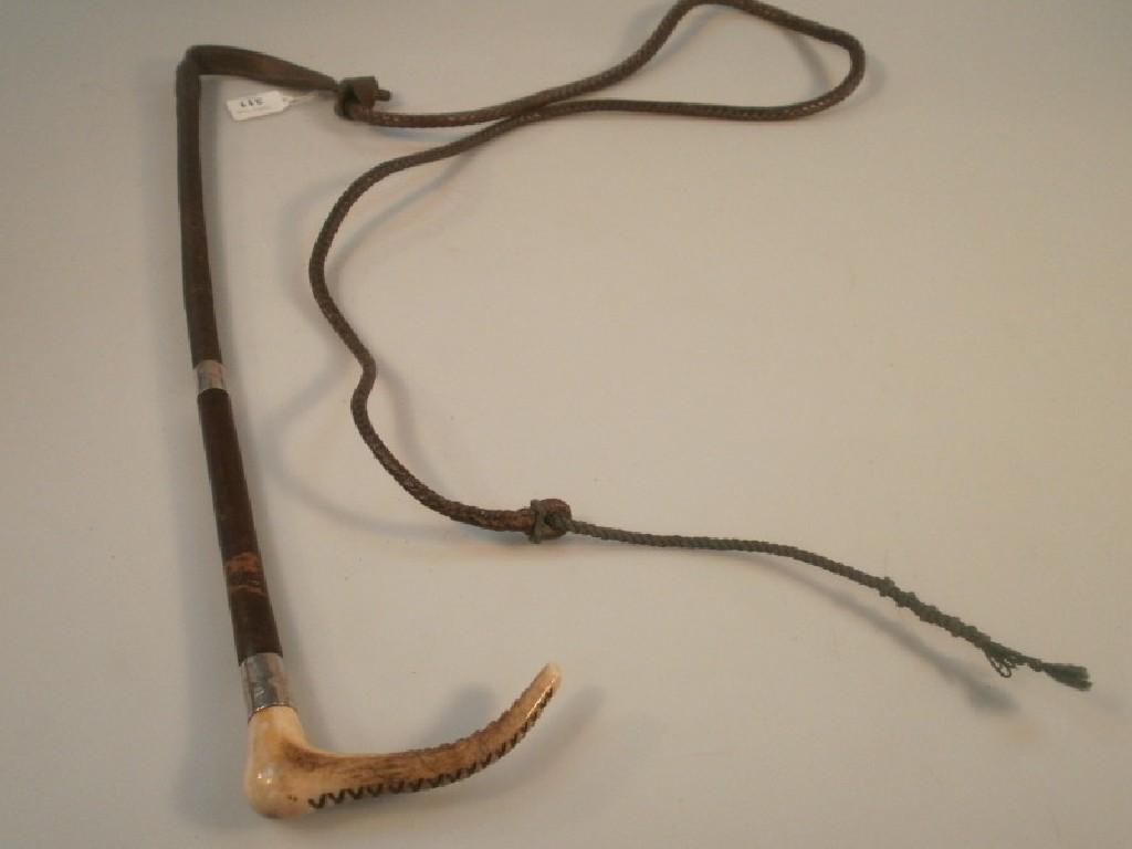 Appraisal: A horn handled leather riding whip with silver mounted engraved