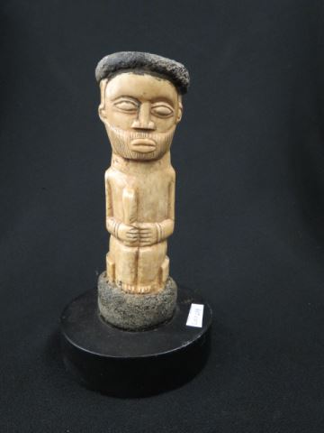 Appraisal: African Carved Bone Tribal Figure seated man plus ebony base