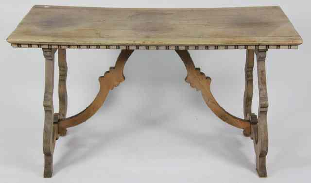 Appraisal: An Italian rectangular walnut trestle type table with shaped supports