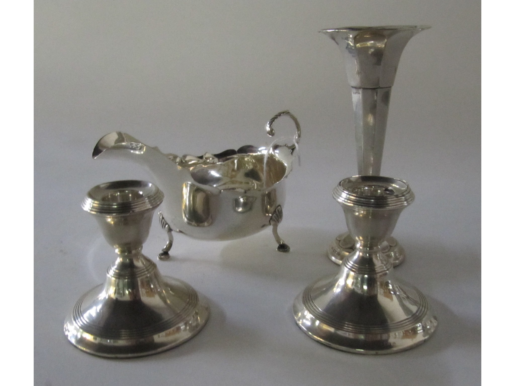 Appraisal: A lot comprising a silver sauceboat Birmingham a silver vase