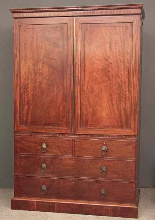 Appraisal: A late Georgian gentleman's figured mahogany wardrobe with low moulded