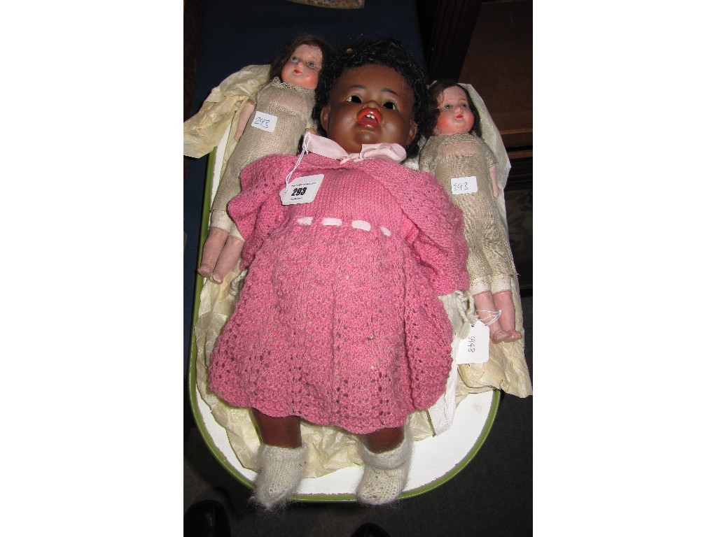 Appraisal: Lot comprising German black girl doll and a pair of