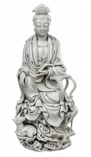 Appraisal: A BLANC-DE-CHINE GUANYIN SEATED ON A ROCK WITH A DEER