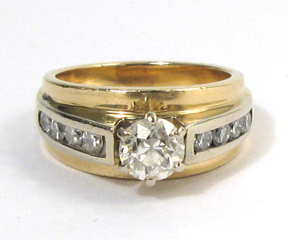 Appraisal: DIAMOND AND FOURTEEN KARAT GOLD RING centering a round brilliant-cut