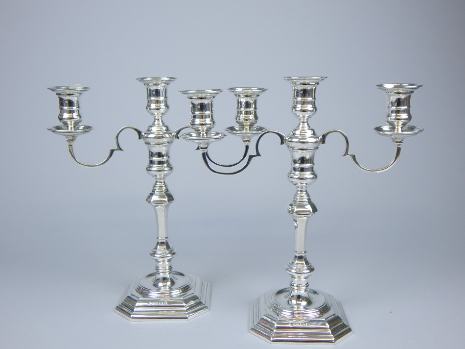 Appraisal: A pair of silver three branch candelabra mid thC style