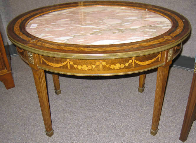 Appraisal: CONTINENTAL OVAL MARQUETRY DRINKS TABLE Brass bound top centers a