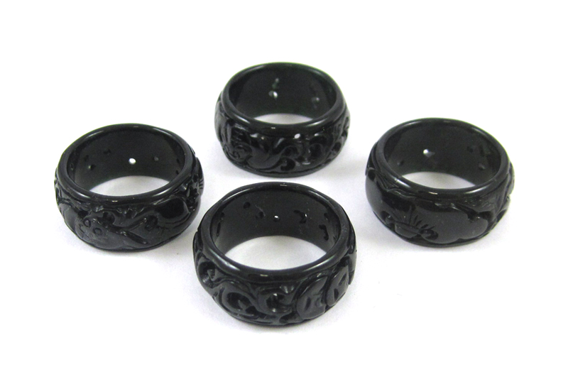 Appraisal: FOUR CARVED BLACK HARDSTONE RINGS together weighing grams Ring sizes