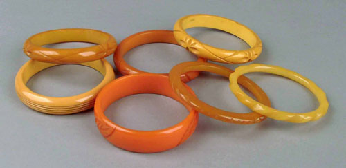 Appraisal: Seven orange and yellow carved bakelite bangles