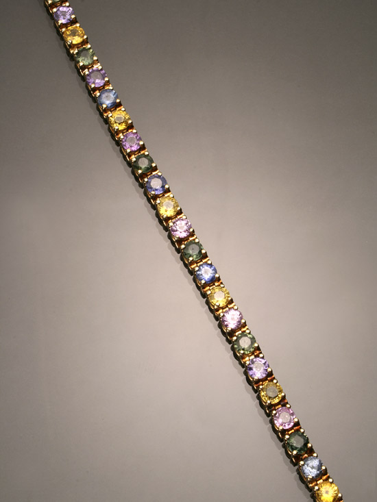 Appraisal: -Karat Yellow-Gold Multi-Colored Sapphire Tennis Bracelet The flexible mount set