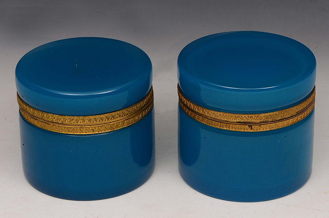 Appraisal: A PAIR OF POWDER BLUE OPALINE CYLINDRICAL GLASS JARS with