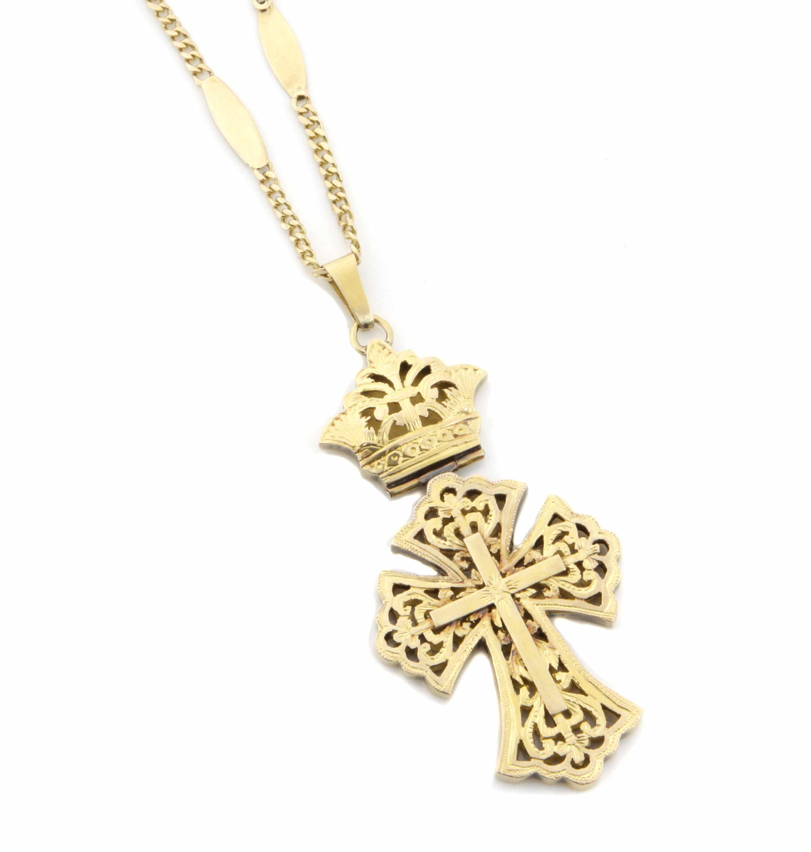 Appraisal: A gold openwork cruciform pendant with a gold chain pendant