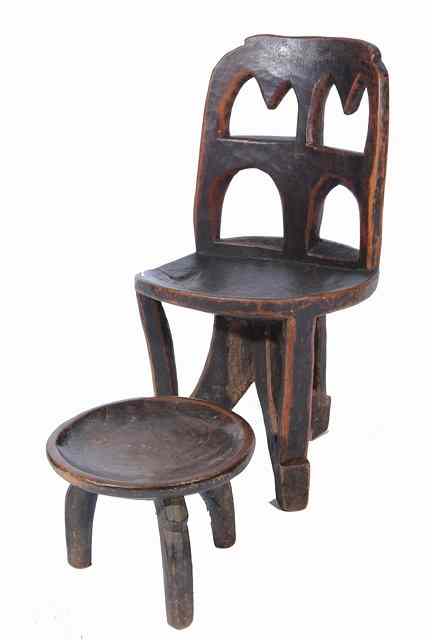 Appraisal: AN ETHIOPIAN CARVED WOODEN CEREMONIAL CHAIR with a quartered open