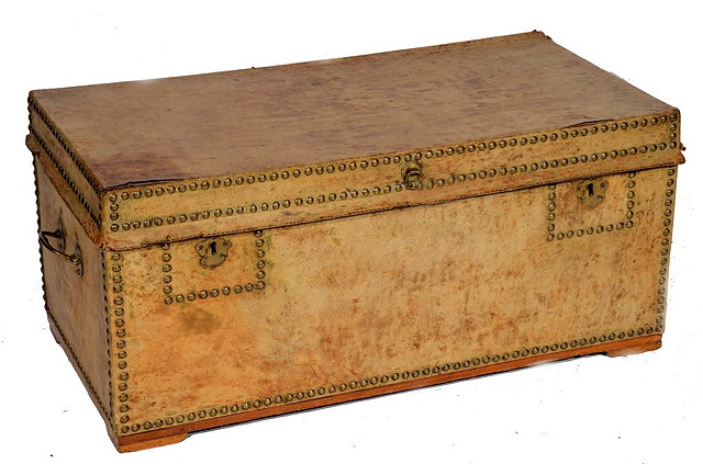 Appraisal: AN ANTIQUE TAN HIDE COVERED AND BRASS STUDDED TRUNK with