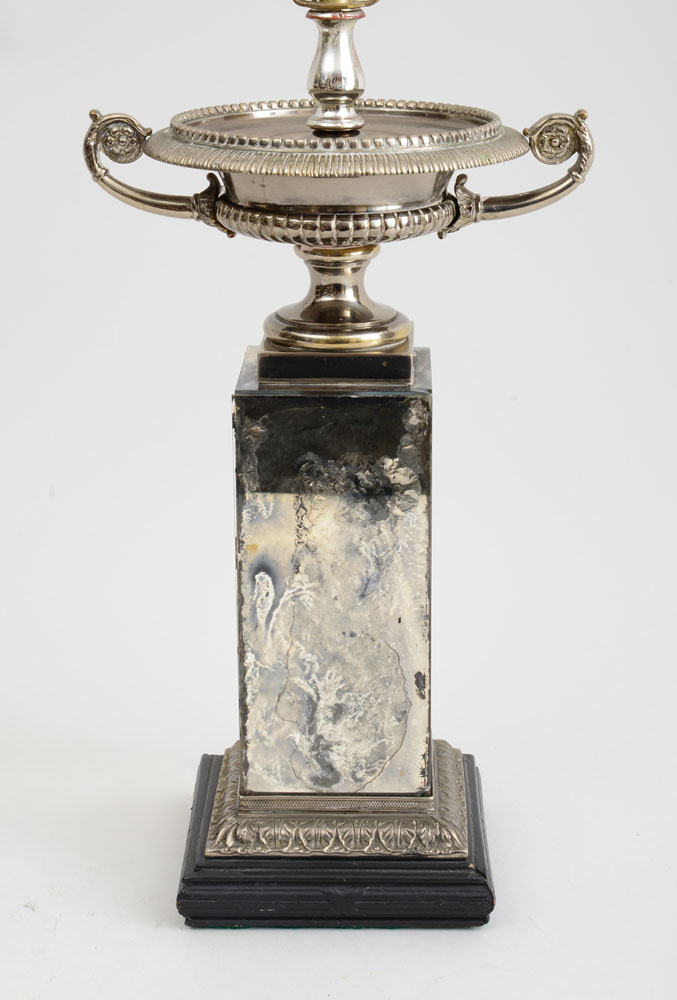 Appraisal: NEOCLASSICAL STYLE SILVER-PLATED TWO-HANDLED URN ON MIRRORED GLASS PEDESTAL MOUNTED