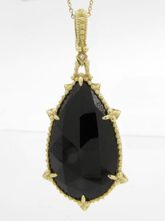 Appraisal: An K yellow gold long pear shaped faceted onyx stone