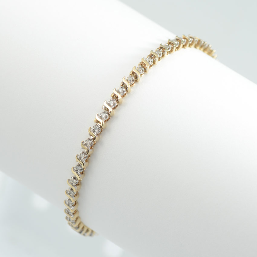 Appraisal: DIAMOND TENNIS BRACELET K yellow gold bracelet contains round full