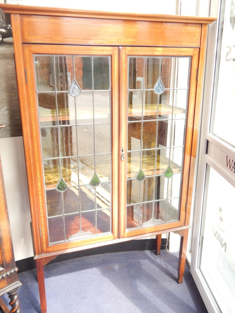 Appraisal: An early thC Sheraton Revival inlaid mahogany display cabinet with