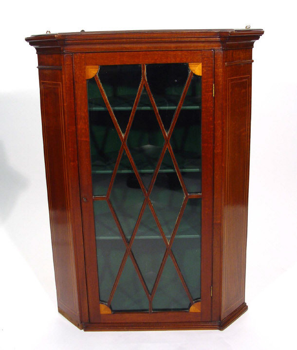 Appraisal: Edwardian inlaid mahogany hanging corner cabinet fitted a glazed door