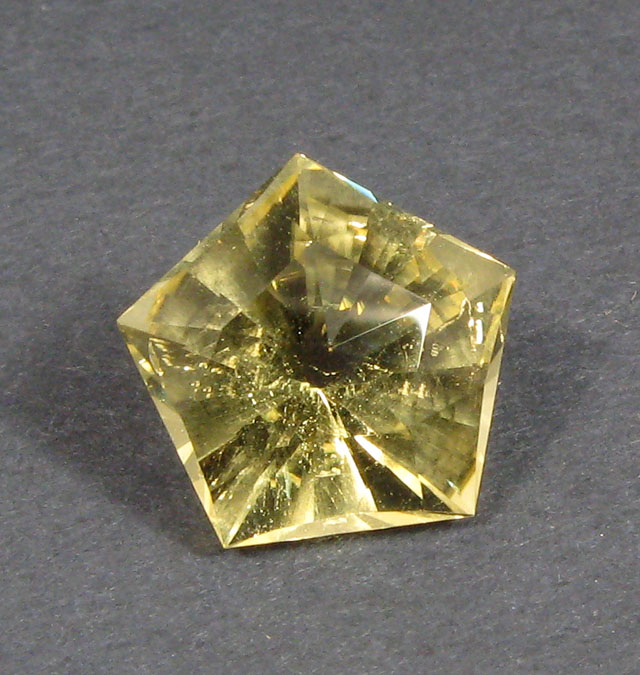 Appraisal: UNSET GOLD BERYL GEMSTONE The pentagon-cut gold beryl weighs cts