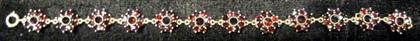 Appraisal: karat yellow gold garnet bracelet'Flower' segments set with garnet 'petals'