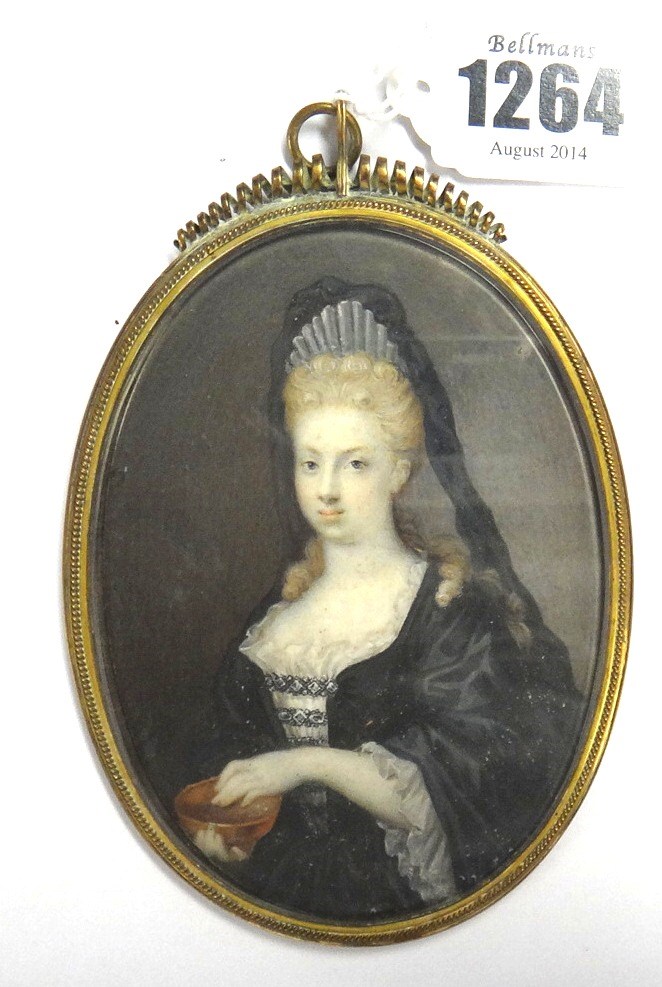 Appraisal: An oval portrait miniature of a lady with pale brown