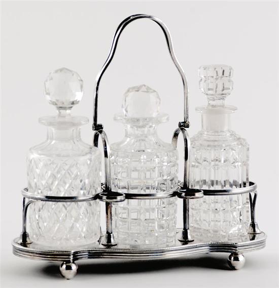 Appraisal: Georgian silverplate decanter set circa hinged handle on shaped frame