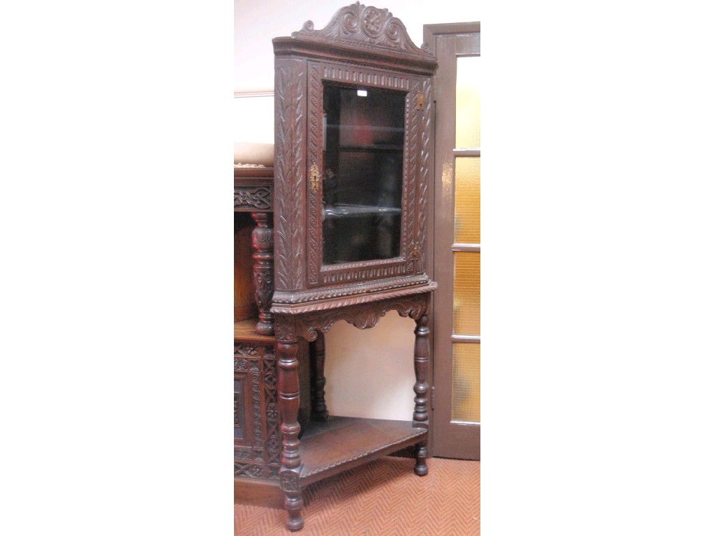 Appraisal: A Georgian oak corner cabinet with later carved decoration and