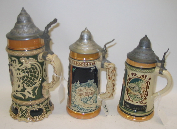 Appraisal: A GROUP OF THREE GERMAN GLAZED POTTERY BEER STEINS One