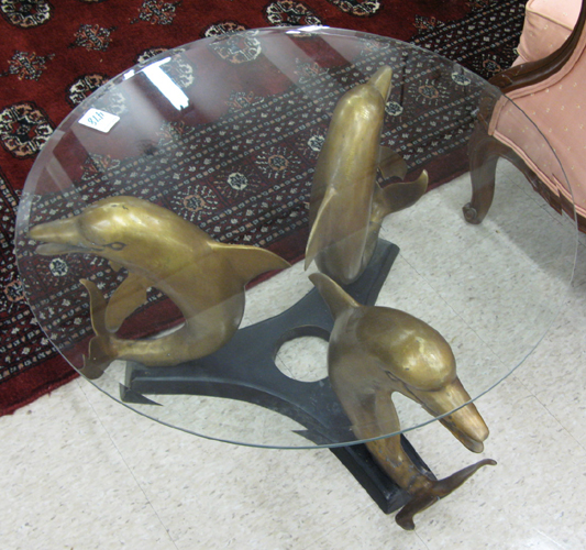 Appraisal: BRONZE DOLPHIN COCKTAIL TABLE having a circular glass top resting