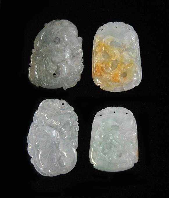 Appraisal: FOUR CHINESE CARVED JADE PENDANTS All four transparent light green