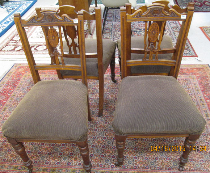 Appraisal: A SET OF FOUR CARVED AND UPHOLSTERED OAK DINING CHAIRS