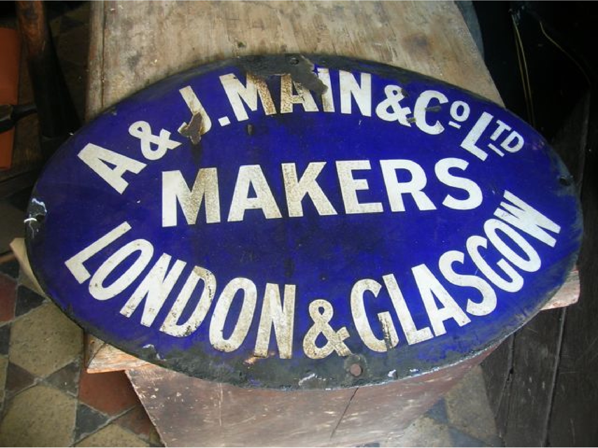 Appraisal: A small vintage enamel sign of oval form with blue