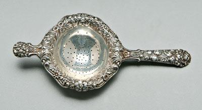 Appraisal: Kirk Repouss eacute tea strainer one long handle one lugged