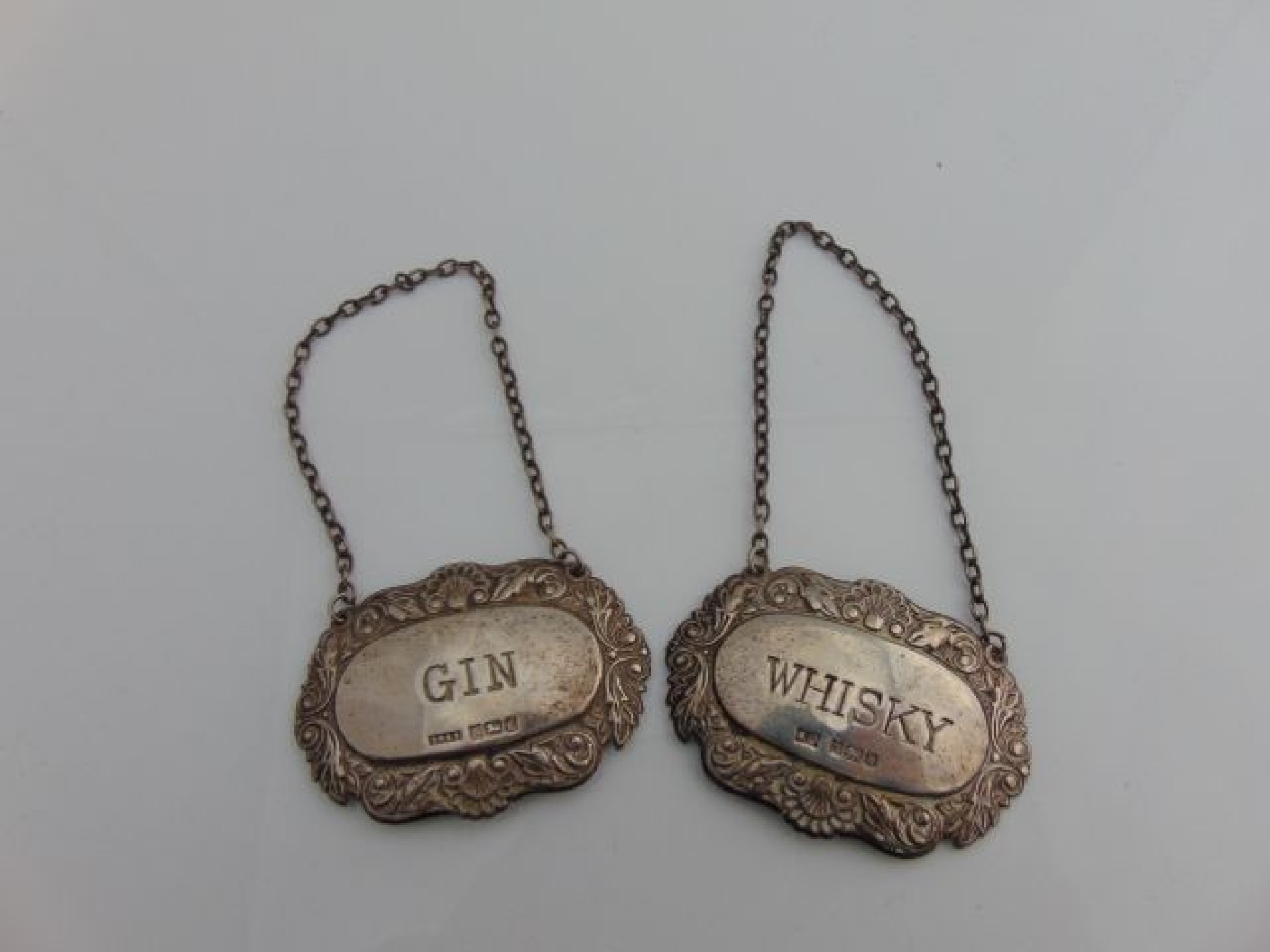 Appraisal: Two silver decanter labels various makers Birmingham one for Whisky