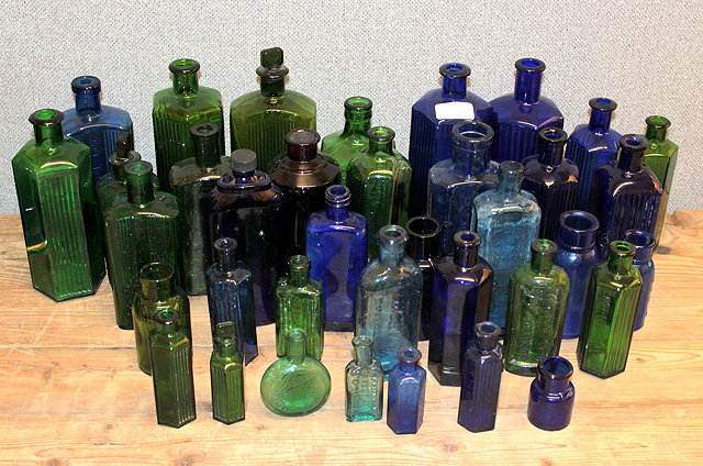 Appraisal: A COLLECTION OF VARIOUS BLUE AND GREEN GLASS MEDICINE AND