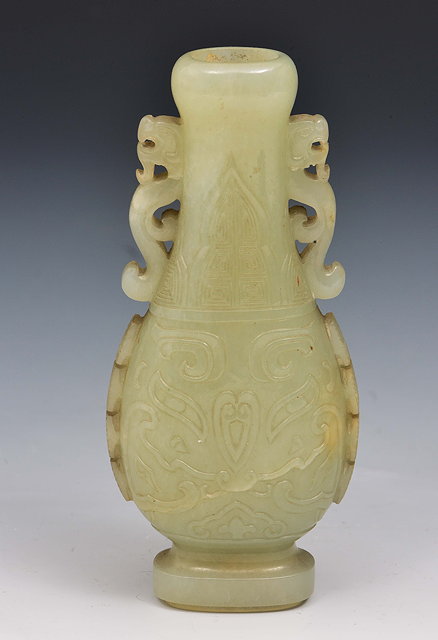 Appraisal: A Chinese pale green jade two dragon handled vase th