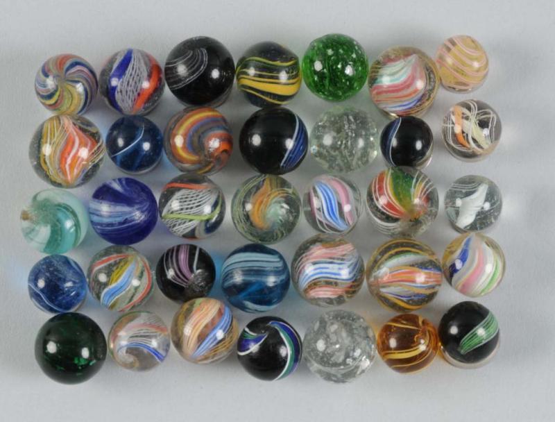 Appraisal: Assortment of Handmade Marbles Description Includes approximately marbles with a