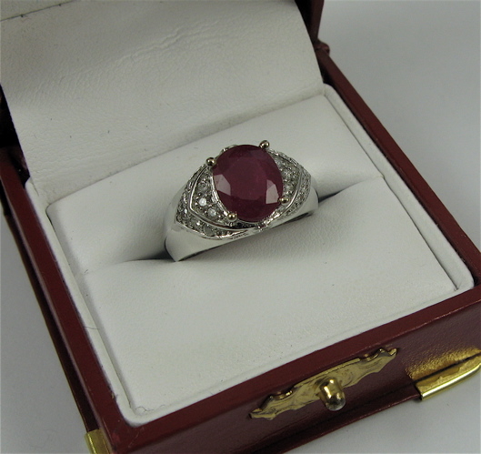 Appraisal: RUBY DIAMOND AND K WHITE GOLD RING centering an oval-cut