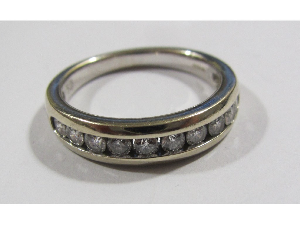 Appraisal: Eighteen carat white gold channel set diamond half hoop ring