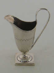 Appraisal: A late Victorian silver helmet shaped cream jug on square