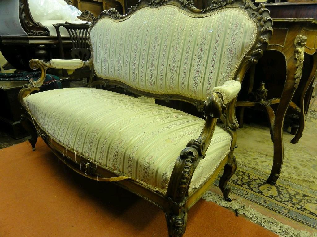 Appraisal: A th century continental settee with upholstered seat and button