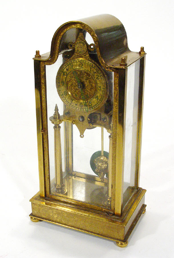 Appraisal: Brass skeleton clock with lion mask pendulum in a glazed