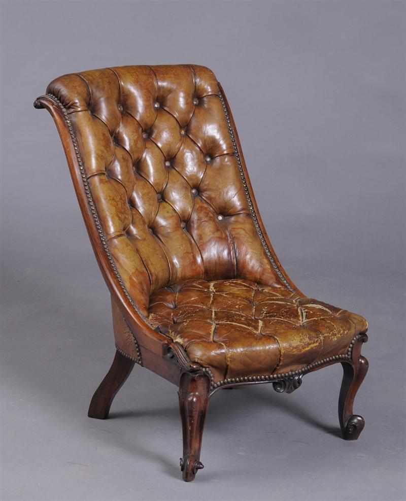 Appraisal: VICTORIAN CARVED MAHOGANY SLIPPER CHAIR With buttoned leather s-form back