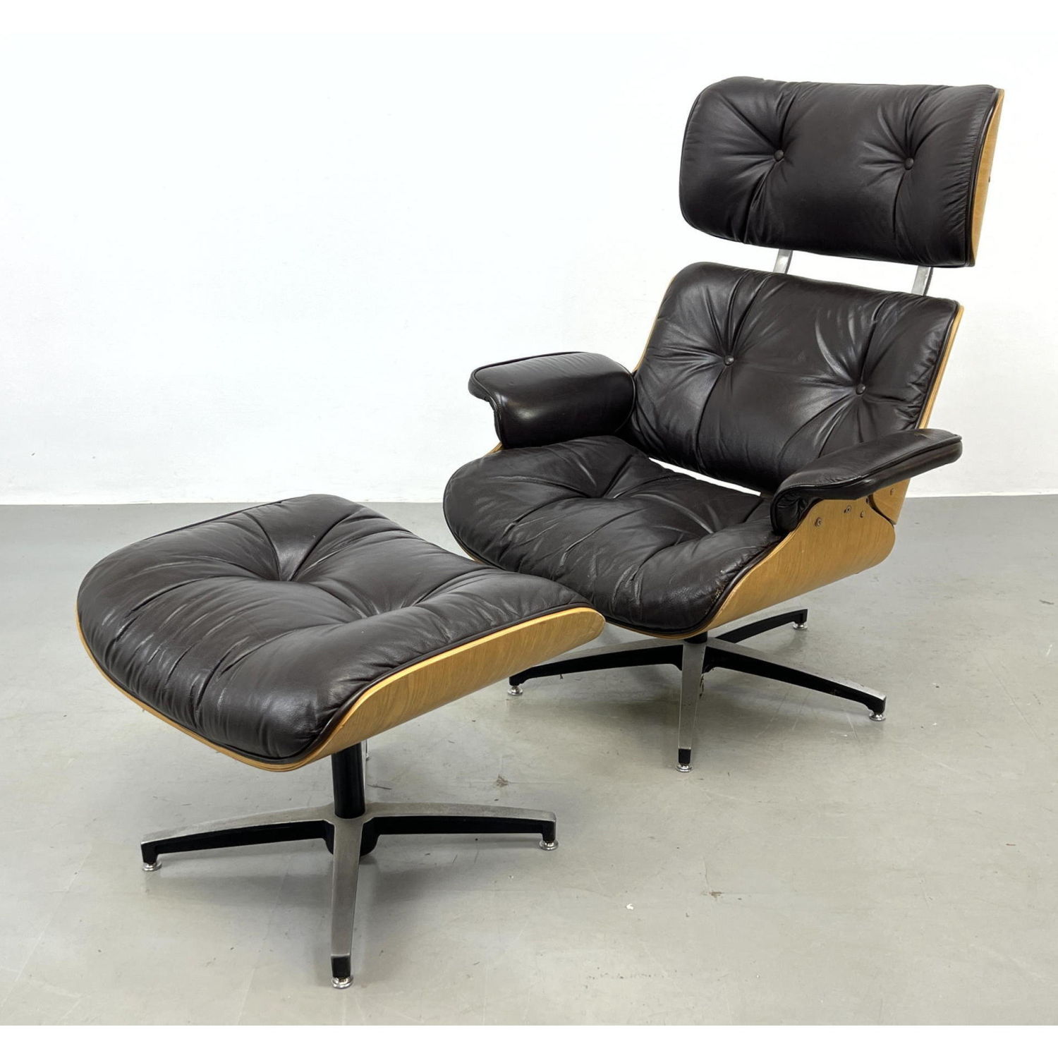 Appraisal: pc Eames style Lounge Chair and Ottoman Chair wobbles on