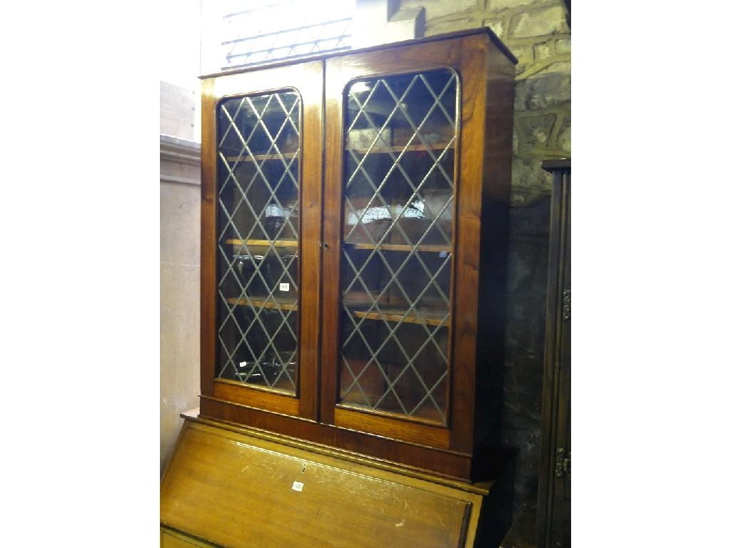 Appraisal: A Victorian mahogany bookcase enclosed by a pair of arched