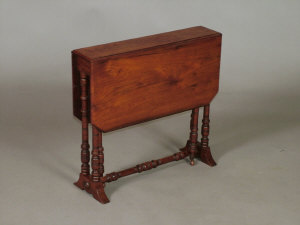 Appraisal: An Edwardian walnut Sutherland table the chamffered top upon ring